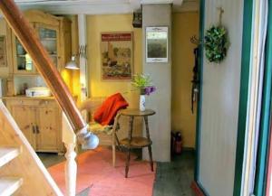 a room with a staircase and a table in a room at Villa Ilsebill in Ribnitz-Damgarten +10 photos