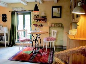 a table and chairs in a room with a window at Villa Ilsebill in Ribnitz-Damgarten