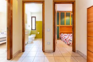a bedroom with a bed and a bathroom at Magy House in Quartu SantʼElena +12 photos