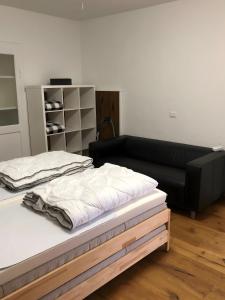 a bedroom with a bed and a black couch at Villa Wetzel Domaso in Montemezzo +58 photos