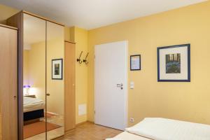 a bedroom with a bed and a door to a bathroom at Ferienwohnung Tannenblick 1-2 in Oberhof