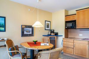 a kitchen with a table and chairs in a room at Ferienwohnung Tannenblick 1-2 in Oberhof