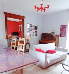 a living room with a white couch and a table at Maison L'oustal Du Lévéjac in Saint-Rome-de-Tarn +17 photos
