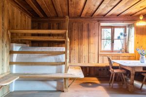 a room with a bunk bed and a table at Egger an der Lahn - Apt Nonno in San Genesio Atesino +20 photos