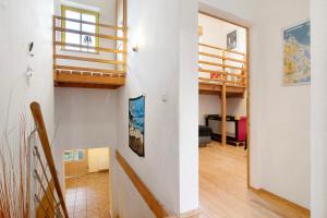 a living room with a staircase and a loft at Ferienhaus Poggenkrug Halbsguth in Wolgast