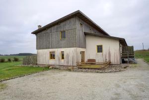a large house with a gambrel roof at Ferienhaus Poggenkrug Halbsguth in Wolgast
