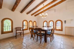 a dining room with a wooden table and chairs at Casa Argentera Full House in Argentera