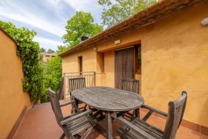 a wooden table and chairs on a balcony at Casa Argentera Full House in Argentera