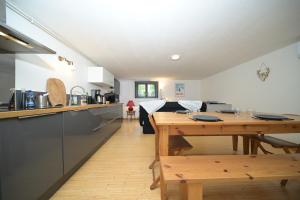 a kitchen and dining room with a wooden table at Chalet Appartement Les Isards in Saint-Lary-Soulan +13 photos