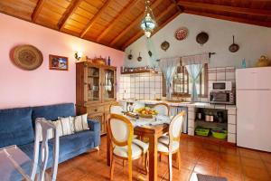 a living room with a table and a blue couch at La Roquina in Tijarafe +15 photos