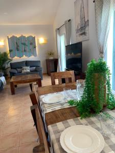 a living room with a table and a couch at Chalet con piscina en Menorca in Cala en Bosc