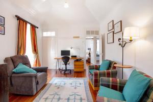 a living room with a couch and chairs and a desk at Mother's House in Calheta