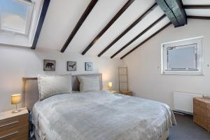 a bedroom with a large bed and two windows at Auszeit Sauerland in Olsberg