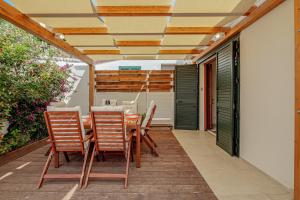 a patio with a table and chairs on it at Villa Poldina in Budoni