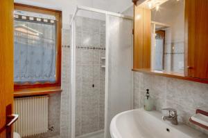 a bathroom with a sink and a shower at Residence Malibu Appartamento 2 in Falcade