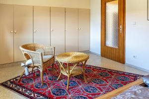 a room with two chairs and a table on a rug at Haus Elfi in Hausen am Tann