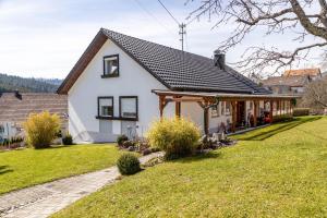 a white house with a gambrel roof at Haus Elfi in Hausen am Tann