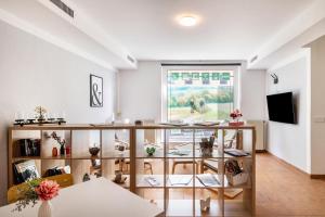 a living room with a large window and a table at Ferienwohnung in Mecklenburg in Malchin