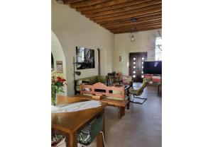 a living room with a table and chairs at Villa Two Pine Trees in Alinda