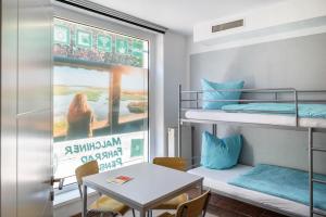 a room with two bunk beds and a table at Ferienwohnung in Mecklenburg in Malchin