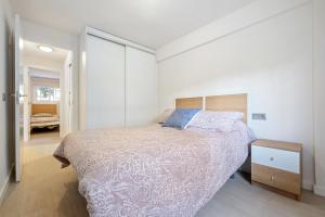 a bedroom with a large bed and a night stand at Logroño in Salou +15 photos