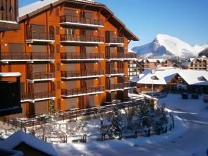 a building in the snow with snow at studio la joue du loup in Le Dévoluy