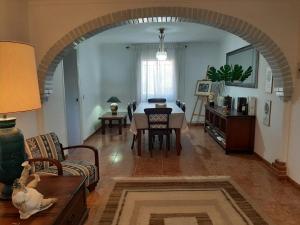 an archway in a living room with a table and chairs at Cortijo Ramonsillos in Villanueva del Trabuco +33 photos