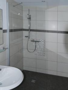a bathroom with a shower and a sink at Ferienwohnung Lahr in Lahr +10 photos