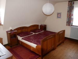 a bedroom with a wooden bed and a lamp at Ferienwohnung Lahr in Lahr