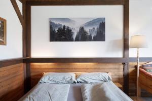 a bedroom with two beds and a picture on the wall at Appartment Auszeit in Schönwald