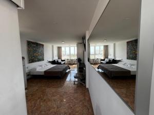a large room with two beds and a mirror at Loft Molinos Corner in San Bartolomé