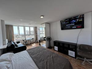 a bedroom with a bed and a flat screen tv at Loft Molinos Corner in San Bartolomé