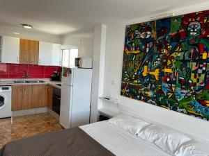 a kitchen with a large painting on the wall at Loft Molinos Corner in San Bartolomé
