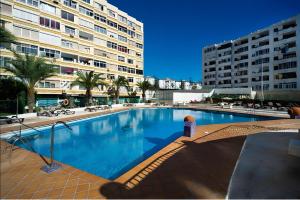 a large swimming pool in front of a large building at Loft Molinos Corner in San Bartolomé