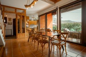 a dining room with a wooden table and chairs at Casa Carmen in La Vega