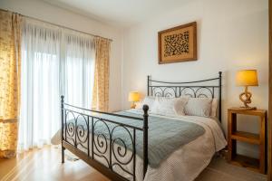 a bedroom with a black bed and a window at Casa Carmen in La Vega