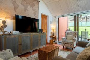 a living room with a flat screen tv on a entertainment center at Casa Carmen in La Vega