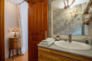 a bathroom with a sink and a mirror at Casa Carmen in La Vega +29 photos