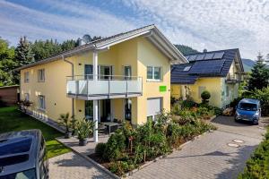 a yellow house with solar panels on top of it at Im Rosengarten 2 in Zell am Harmersbach