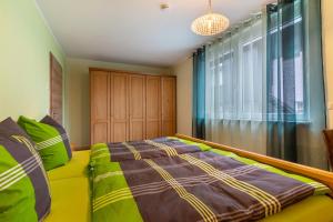a bedroom with a bed and a large window at Im Rosengarten 2 in Zell am Harmersbach