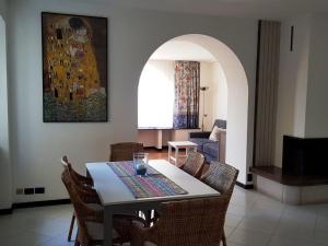a dining room with a table and chairs at Apartment CASA SPIAGGIA by Interhome in Castelletto di Brenzone