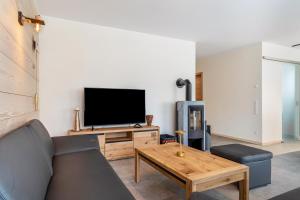 a living room with a couch and a tv at Im Rosengarten 2 in Zell am Harmersbach