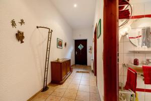 a hallway with a bathroom with a shower and a door at Eulennest 1 in Minheim +14 photos