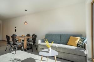 a living room with a couch and a table at Sunnig Apartment Abendsonne in Vollan +12 photos