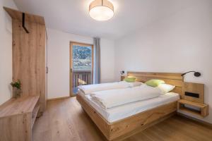 a bedroom with a large bed with a wooden headboard at Sunnig Apartment Abendsonne in Vollan