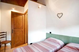 a bedroom with a bed and a heart on the wall at Casa Verde - Sciu´ Pepin in Rezzo