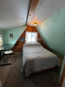 a bedroom with a bed in a small room at Red Sleigh Chalet - Campton in Campton