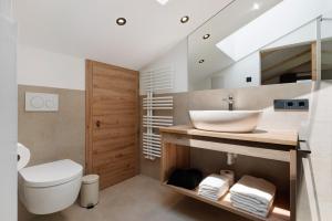 a bathroom with a sink and a toilet at Daunëihof in Selva di Val Gardena +94 photos