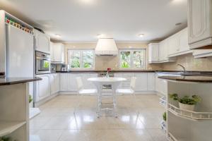 a kitchen with white cabinets and a white table at Moli dels Reis in Palma de Mallorca