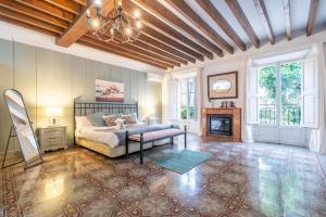 a living room with a bed and a fireplace at Moli dels Reis in Palma de Mallorca